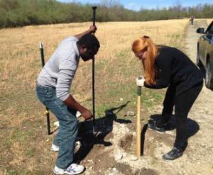 Oyeniyi Abe (left) of Nigeria and Raffaella Taylor-Seymour of London dig a post hole for a new fence on a former strip mine site. 